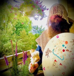 Bearded figure with drum and fringed headdress